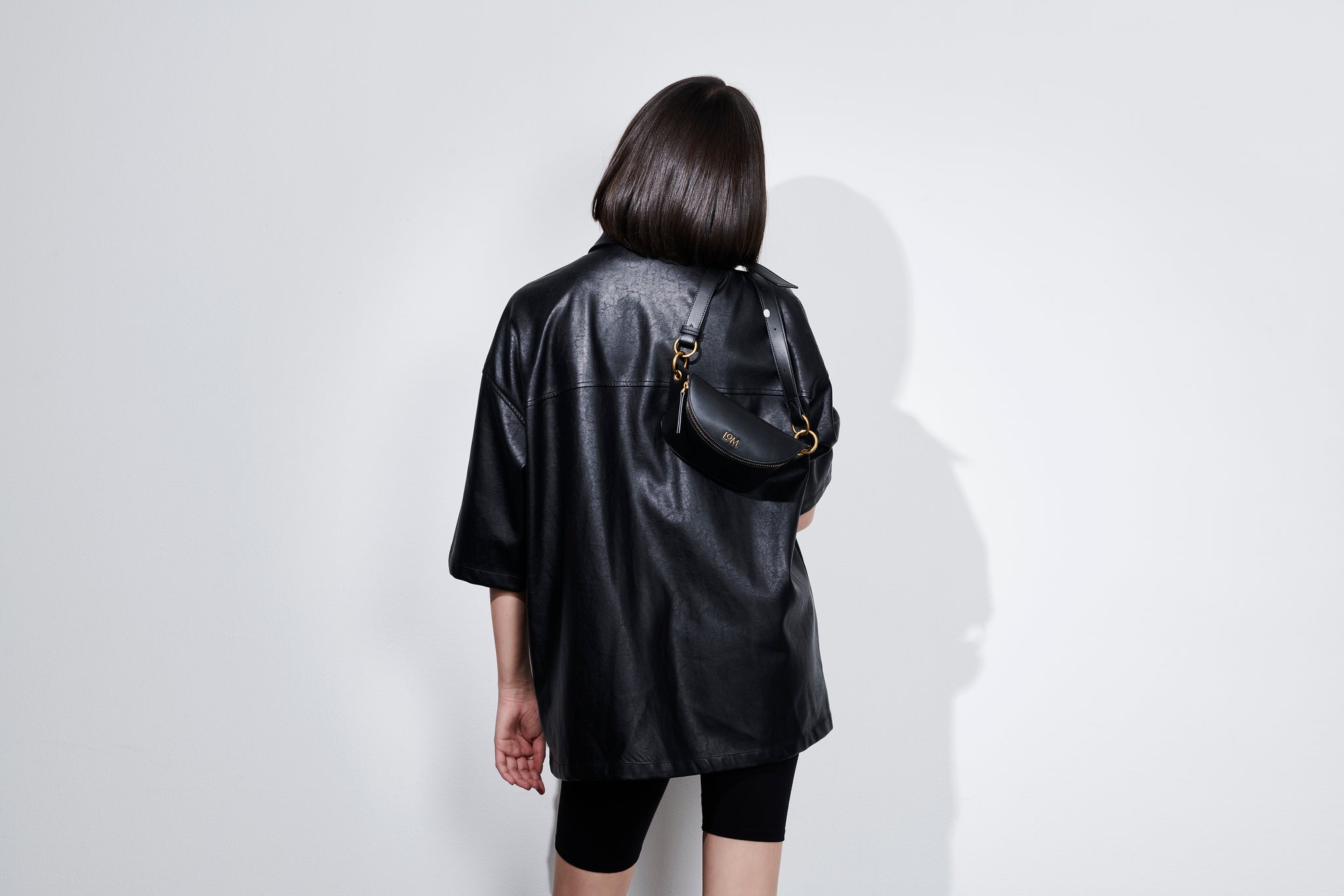 LOM Australia - Model wears Leia Belt Bag in sustainable, vegan, black cactus leather.