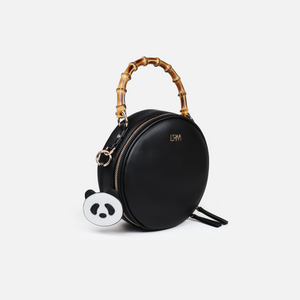 Circulat handbag with bamboo handle and detachable panda keyring. Made from premium black cactus leather, light gold hardware, black organic cotton lining.