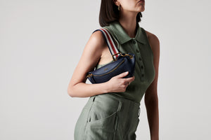 LOM Australia - model wears Stella Belt Bag in navy vegan cactus leather with Chamaeleon Red, White & Navy cotton webbing strap.
